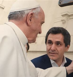 Arnoldo Mosca Mondadori enseña al Papa una cruz hecha con la madera de los barcos